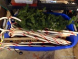 (GAR) TUB LOT OF CHRISTMAS DECORATIONS: MOSTLY YARD CANDY CANES, SMALL CHRISTMAS TREE PIECE.