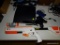 (B) SONY PLAYSTATION 3 WITH CONTROLLERS, MANUAL, MOVEMENT CONTROLLERS, CORDS, AND A CABELA'S RIFLE