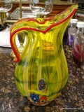 (K) ART GLASS PITCHER; YELLOW WITH RED ACCENTS AND JUST A TOUCH OF ROYAL BLUE. MEASURES 12.5