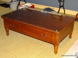 (B) KELLER COFFEE TABLE; MADE OF SOLID OAK WITH ONE LARGE STORAGE DRAWER ON EACH SIDE (2 TOTAL) ,