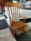 (R2) OAK ROCKING CHAIR; 5 SLATS ON BACK AND 3 SUPPORTING EACH ROLLED ARM. GREAT CONDITION. MEASURES