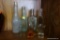 (R2) GLASS BOTTLE LOT; INCLUDES TOTAL OF 5 BOTTLES IN CLEAR OR GREEN, AND TWO SMALL CORDIAL GLASSES.