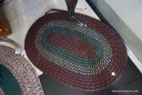 (R1) SMALL OVAL SHAPED BRAIDED RUG; MOSTLY MAROON WITH DARK GREEN ACCENTS. EVERY 80'S KID KNEW WHERE