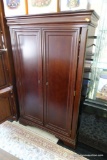 (R4) ARMOIRE; CHERRY ARMOIRE THAT HAS 2 DOORS THAT OPEN TO REVEAL 2 SHELVES OVER 3 DRAWERS. THIS