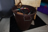 (BACK) BROWN PLASTIC TRASH BIN WITH MISC. ITEMS INCLUDE.