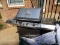 (PAT) OUTDOOR GRILL; WITH COVER. MADE BY THERMOS, HAS DUAL BURNERS. LOCATED ON PATIO.