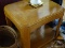 (LR) END TABLE; SQUARE LIGHT WOOD FINISH. ROUNDED CORNERS REFLECT MODERN STYLING, AS DOES THE