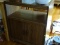 (FOY) MICROWAVE CART; WOOD GRAIN PRINTED WITH SHELF AND LOWER STORAGE CABINET AND WHEELS. MEASURES