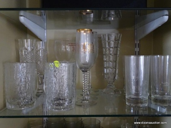 (LR) SHELF LOT OF GLASS DRINKWARE; INCLUDES TALL CHAMPAGNE FLUTES, TEXTURED TUMBLERS, ETCHED TEA