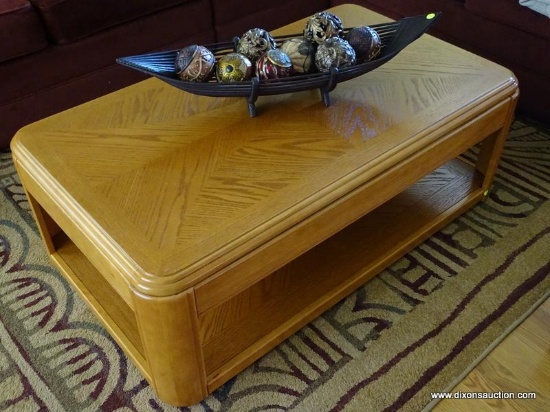 (LR) COFFEE TABLE; RECTANGULAR LIGHT WOOD FINISH, MODERN STYLE TABLE. HAS ROUNDED CORNERS AND LOWER