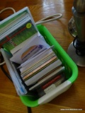 (TAB) 2 GREEN PLASTIC STORAGE BINS WITH ASSORTED CASSETTE TAPES AND CD'S INSIDE, ALSON WITH SEVERAL