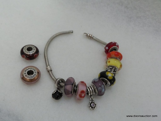 PANDORA STERLING SILVER BRACELET WITH NINE PANDORA MURANO CHARMS AND ASSORTED SPACERS. BRACELET