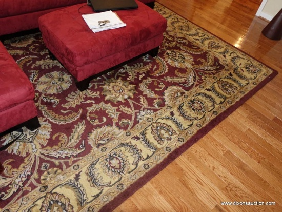 (LR) AREA RUG IN GOLD AND RUST WITH FLORAL/LEAF STYLE PATTERN: 10' 6" X 7' 11"