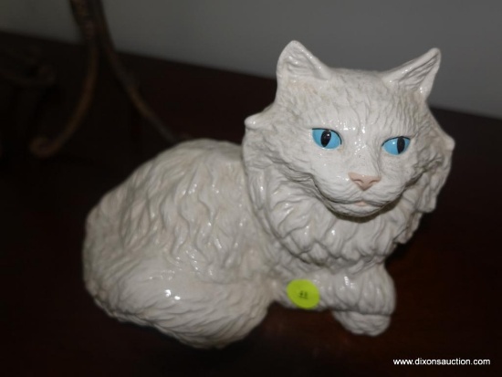 (BR2) PORCELAIN FIGURINE OF A LOUNGING CAT WITH BLUE EYES: 9" X 6"