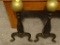 (LR) PAIR OF WROUGHT IRON FIREPLACE ANDIRONS WITH BRASS BALL TOPS AND CURVED LEGS; EACH MEASURES 16
