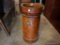 (GAR) LEATHER CYLINDRICAL CANISTER WITH HANDLE AND WORN SIDE REGAL CREST DETAIL. POSSIBLY USED FOR A