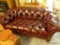 (LR) SMALL LEATHER COUCH; BUTTON-TUFTED CHOCOLATE BROWN LEATHER IS IN EXCELLENT CONDITION. ATTENTION