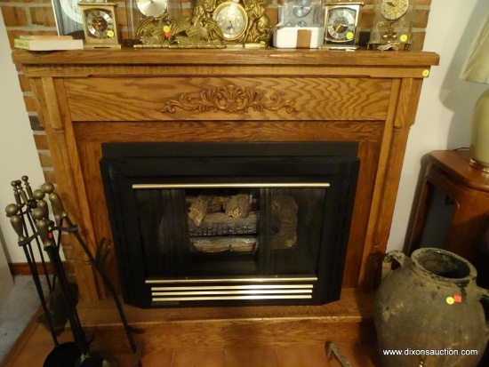 (LR) LARGE WOODEN ELECTRIC FIREPLACE; LIGHT OAK CABINET WITH MOLDING AT TOP AND BOTTOM WITH CARVED