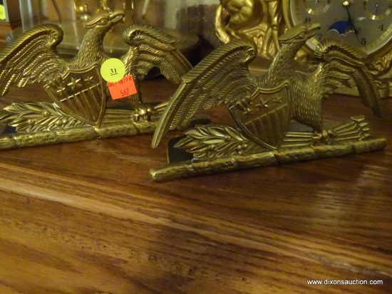 (LR) BRASS FEDERAL EAGLE AND SHIELD BOOKENDS; PAIR SITTING ON MANTLE. EACH MEASURES ABOUT 9" LONG.