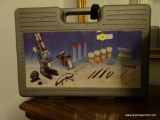 (BR3) VINTAGE MICROSCOPE SET IN GREY HARDSIDE CASE. ALL COMPONENTS APPEAR TO BE PRESENT (MICROSCOPE,