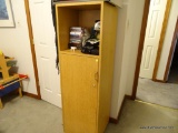 (BR3) MAPLE FINISH 1 SHELF AND 1 DOOR STORAGE CABINET. DOOR OPENS TO REVEAL 4 SHELVES FOR ADDED