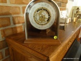 (LR) VINTAGE VERICHRON MANTEL-STYLE WORLD CLOCK; ARCHING ALUMINUM DOME TOP AND OAK BASE. BEAUTIFULLY