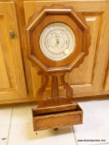 (K) WOOD WALL BAROMETER BY HOWARD MILLER; INTRICATELY CARVED DESIGN, ROUND FACE, OCTAGONAL TOP