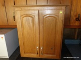 (GAR) LIGHT WOOD HANGING CABINET; GREAT FOR EXTRA BATHROOM SPACE. MEASURES 25