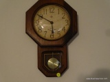 (LR) ELGIN WESTMINSTER CHIME WOODEN WALL CLOCK; OCTAGONAL DESIGN WITH PENDULUM INTACT. DARK WOOD,