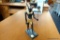 (R3) EGYPTIAN FIGURINE DEPICTING ANUBIS, THE GOD OF THE UNDERWORLD STANDING ON A BLACK BASE; GOLD