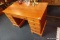 (R5) MODERN WOODEN KNEEHOLE DESK; 4 DRAWERS ON EITHER SIDE OF A CENTRAL DRAWER, EACH WITH ROUND