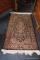 (R5) ORIENTAL AREA RUG; BLACK BACKGROUND WITH ROSE COLORED FLORAL PATTERN AND BORDER AND CREAM