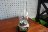 (R2) BRASS SQUARE BASE OIL LAMP WITH GLASS GLOBE; MEASURES 6 IN TALL AND 2.5 IN WIDE.