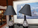 (R4) PAIR OF BLACK AND WHITE ZEBRA TABLE/DESK LAMPS WITH MATTE BLACK SHADES; EACH STANDS 19 IN TALL,