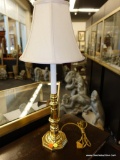 (R5) BRASS FINISH CANDLESTICK STYLE TABLE LAMP WITH CREAM COLORED BELL SHADE; MEASURES 24 IN TALL.