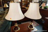 (R4) PAIR OF MATCHING TABLE/BEDSIDE LAMPS; OFF WHITE BELL SHAPED SHADES OVER A GOLD TONE AND BROWN
