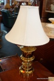 (WIN) TABLE LAMP; BELL SHAPED CREAM COLORED SOLID LAMP SHADE WITH BRASS TONED BODY/BASE. STANDS
