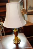 (R5) TABLE LAMP; BRASS URN STYLE POST ON OCTAGON BASE. ORNATE TOP FINIAL. MEASURES 25 IN TALL X 12
