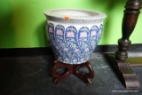 (R1) ORIENTAL STYLE PLANTER ON ROSEWOOD BASE; WHITE WITH BLUE AND PINK FLORAL PATTERN ON ATOP A