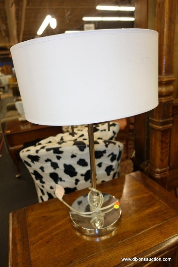 (WIN) CHROME LIKE TABLE LAMP; SLEEK AND MODERN CHROME LIKE METAL LAMP WITH WHITE DRUM SHADE. THE