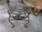 (BED) SMALL WROUGHT IRON FOOTSTOOL; 3 SCROLLING LEGS, PAINTED A LIGHT GREEN , HAS FLORAL DETAIL ON