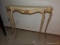 (BAS1) MARBLE TOP DEMILUNE CONSOLE TABLE; CREAM COLORED MARBLE OVER A CARVED APRON AND A 4-LEGGED