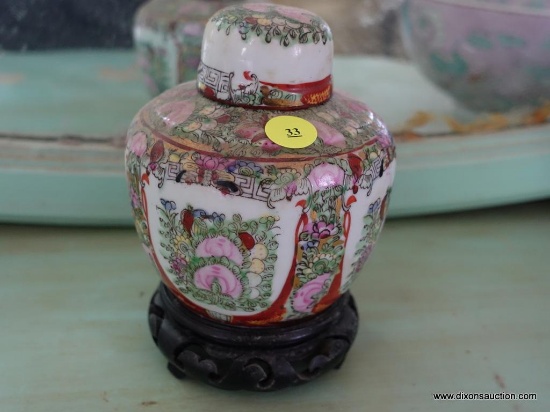 (BED) ORIENTAL STYLE GINGER JAR WITH LID; SITS ON ATTACHED ROSEWOOD VASE, MEASURES 7 IN TALL.