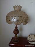 (BAS1) CARVED BASE TABLE LAMP WITH OPALESCENT STAINED GLASS-LIKE PANELED LAMPSHADE; SHADE IS CREAM
