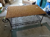 (GAR) WICKER TOP COFFEE TABLE WITH WROUGHT IRON SCROLLING LEGS AND BASE; MEASURES 40 IN X 20 IN X 16