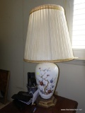 (LR) WHITE TABLE LAMP; BEAUTIFUL WHITE GLASS TABLE LAMP WITH PAINTED FLORAL DESIGN ON THE FRONT.