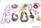 BAG LOT OF VARIOUS COSTUME JEWELRY. INCLUDES A HOT PINK PUKKA SHELL NECKLACE, A LARGE HEART BROOCH,