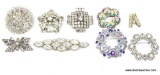 RHINESTONE AND BEADED BROOCH LOT. MOST ARE A WREATH STYLE BROOCH. 1 HAS A SINGLE PEARL CENTER