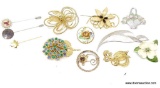 FLORAL BROOCH LOT. INCLUDES A LONG LEAF BROOCH, A LARGE BLUE AND GREEN STONE FLORAL BROOCH, A