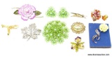 FLORAL BROOCH LOT THAT INCLUDES A VERY LARGE BRIGHT GREEN FLORAL BROOCH WITH MATCHING CLIP ON